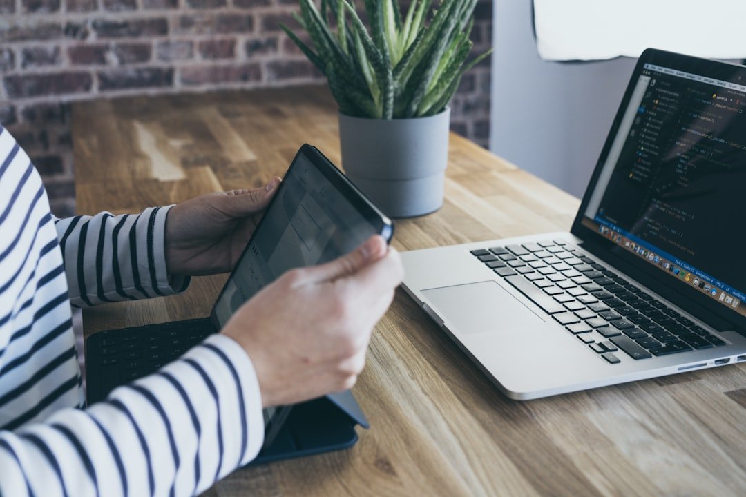 aloe-vera-plant-on-grey-pot-on-table-with-macbook-pro-and-ipad-okuvwmx7n2i